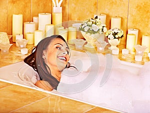 Woman relaxing at bubble bath.