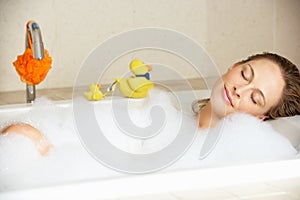 Woman Relaxing In Bubble Filled Bath