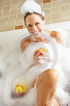 Woman Relaxing In Bubble Filled Bath