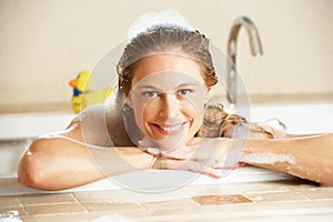 Woman Relaxing In Bubble Filled Bath