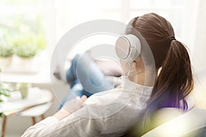 Woman relaxing on the couch and listening to music