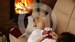 Woman relaxing on couch with warm drink