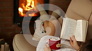 Woman relaxing on couch with warm drink and good book