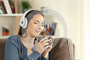 Woman relaxing drinking and listening to music