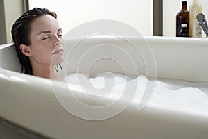 Woman Relaxing With Eyes Closed In Bathtub