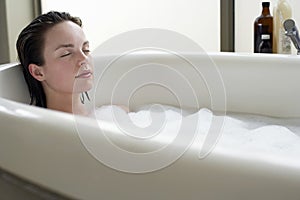 Woman Relaxing With Eyes Closed In Bathtub photo