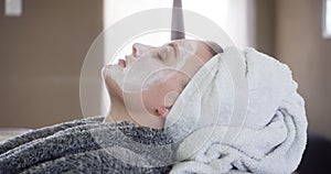 Woman, relaxing and face mask at spa for skincare, beauty and cosmetics for acne prevention. Female person, salon and