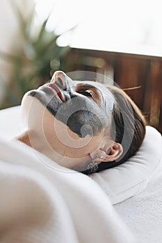 Woman relaxing with a facial mask at the spa