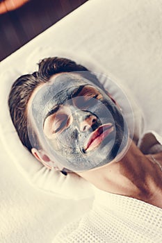 Woman relaxing with a facial mask at the spa