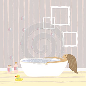 Woman relaxing in the free standing bath with bubble foam . Bathroom interior