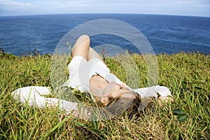 Woman relaxing in grass.