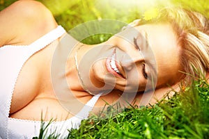 Woman relaxing on grass.