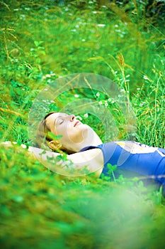 Woman relaxing in green field