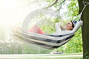 Woman Relaxing In Hammock