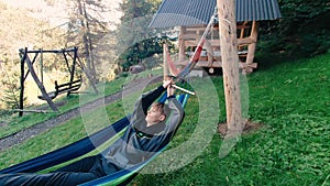 Woman relaxing on hammock and enjoys the scenery in the mountains