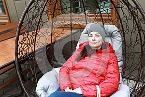 Woman relaxing in hanging chair