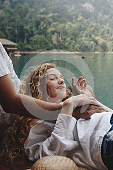 Woman relaxing in her boyfriends lap