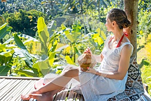 Woman relaxing in her tropical vacation sitting in the jungle