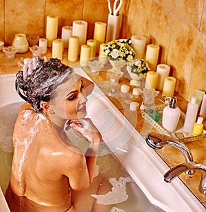 Woman relaxing at home bath.