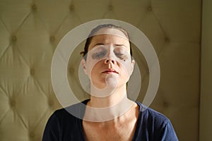 Woman relaxing at home with coffee grounds on her face