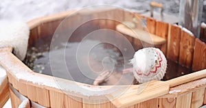 Woman relaxing in hot bath in winter