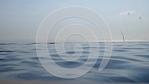 Woman relaxing in infinity swimming pool looking at view