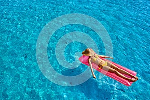 Woman relaxing on inflatable mat float