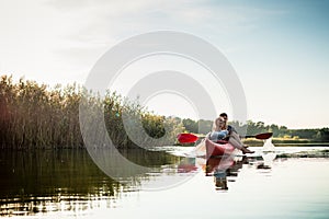 Woman relaxing in kayak with her boyfriend