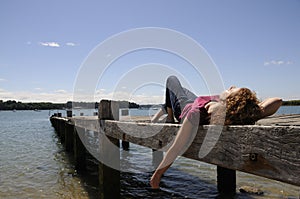 Woman relaxing on landing stage