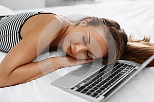 Woman Relaxing With Laptop On Bed. Freelancer Resting. Technology