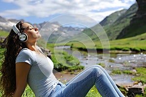 Woman relaxing listening to music with headphones in nature