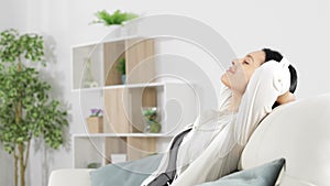 Woman relaxing listening to music at home