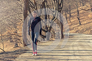 Woman relaxing after a long run in the woods