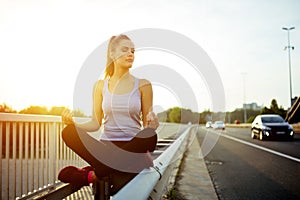 Woman relaxing next to a busy road, challenge concept