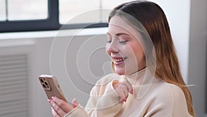 Woman Relaxing Online With Phone At Home