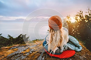 Woman relaxing outdoor bivouac with camping gear summer vacations girl hiking solo enjoying sea view photo