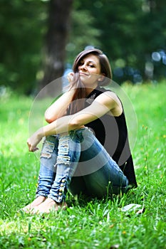 Woman relaxing outdoors looking happy and smiling