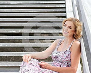 Woman relaxing outside with happy expression