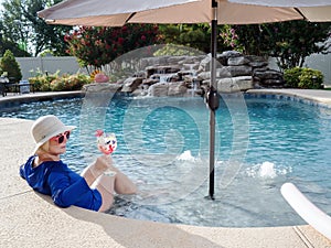 Woman Relaxing in Pool with Drink