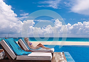 Woman relaxing at the poolside