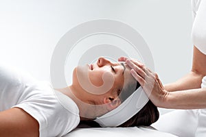 Woman relaxing at reiki session. photo