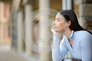 Woman relaxing and resting with closed eyes in the street