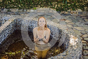 Woman relaxing in round outdoor fragrant herbal bath, organic skin care, luxury spa hotel, lifestyle photo