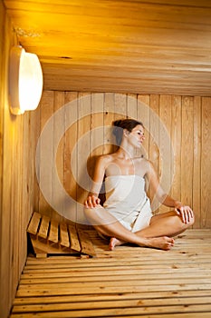 Woman relaxing in a sauna