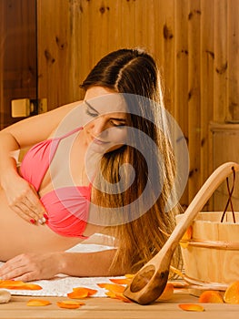 Woman relaxing in sauna. Spa wellbeing.
