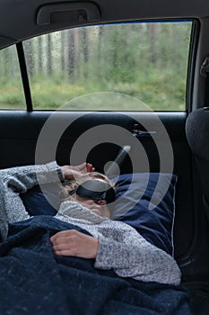 Woman relaxing  and sleeping inside car.Freedom travel concept