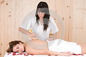Woman relaxing in spa getting massage