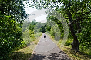 Woman on a relaxing summer walk in a green park