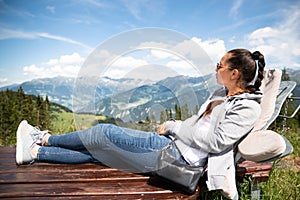 Woman Relaxing In Sun Lounger