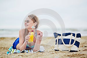 Woman relaxing and sunbathing on beach